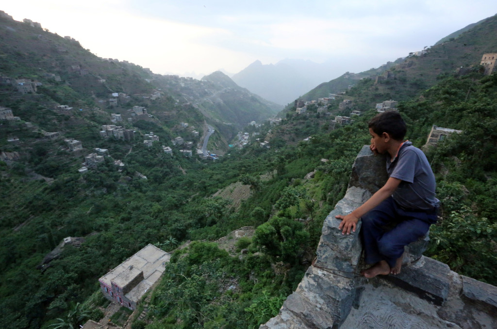 A boy sits on the roof of a house on Dhalamlam Mountain, in the Jafariya district of the western province of Raymah, Yemen June 2, 2016. Reuters Photo/Abduljabbar Zeyad