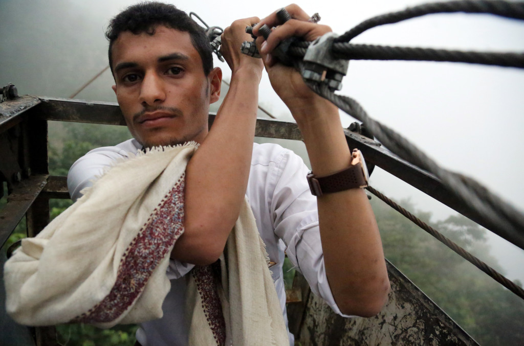 A man rides a cable car that carries people and supplies to Dhalamlam Mountain, in the Jafariya district of the western province of Raymah, Yemen May 31, 2016. Reuters Photo/Abduljabbar Zeyad