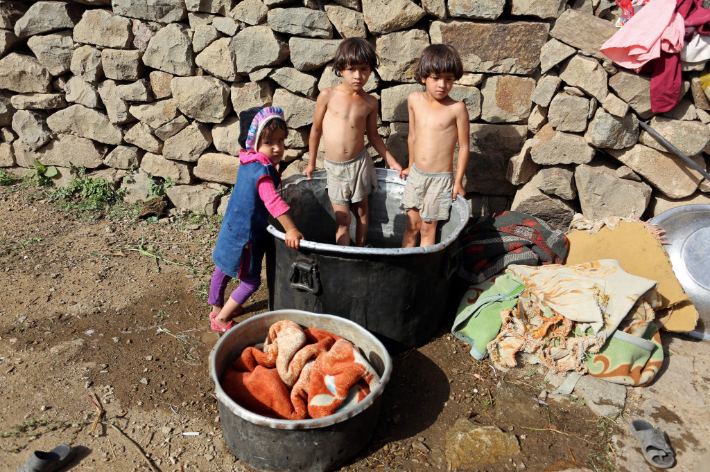 Children stand in a tub where their mothers wash clothes on Dhalamlam Mountain, in the Jafariya district of the western province of Raymah, Yemen June 1, 2016. Reuters Photo/Abduljabbar Zeyad