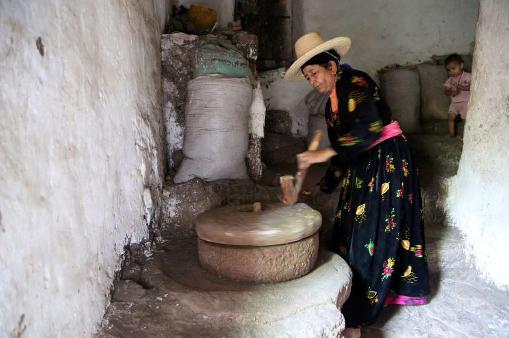 A woman uses a stone grinder to make flour in her house in the mountains, in the Jafariya district of the western province of Raymah, Yemen May 21, 2016. Reuters Photo/Abduljabbar Zeyad