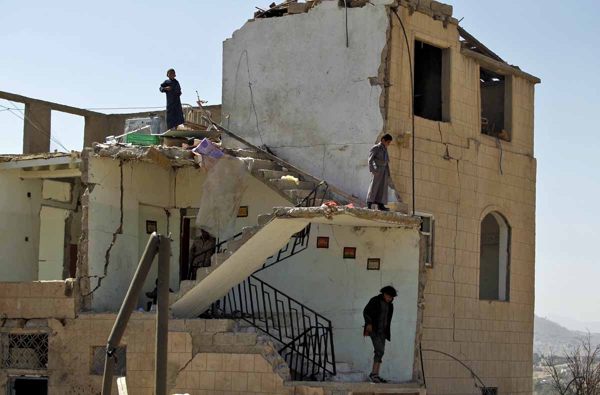 Boys wander amidst the rubble of a house destroyed by Saudi-led coalition air strikes two days earlier on the outskirts of the Yemeni capital Sanaa on November 14, 2016.