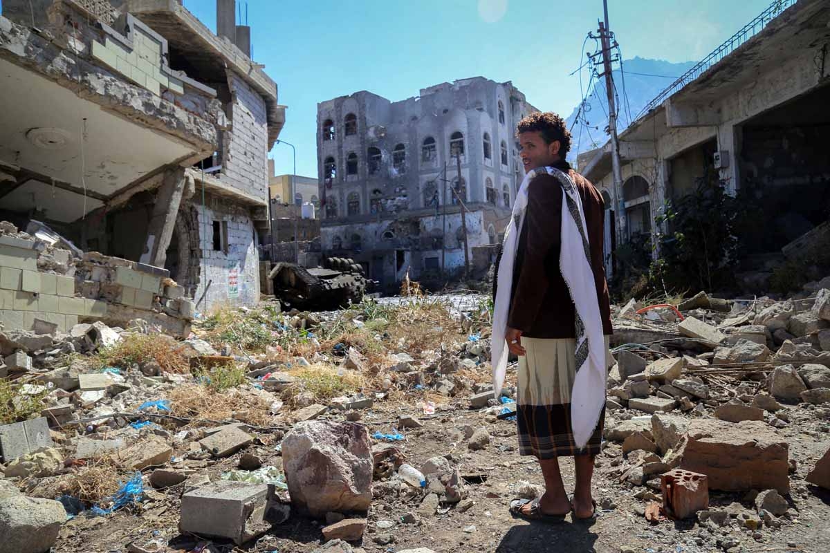 A Yemeni man inspects the damage on a street following clashes between pro-government militants, loyal to President Abedrabbo Mansour Hadi, and Shiite Huthi rebels on November 22, 2016 in the country's third-city Taez.
