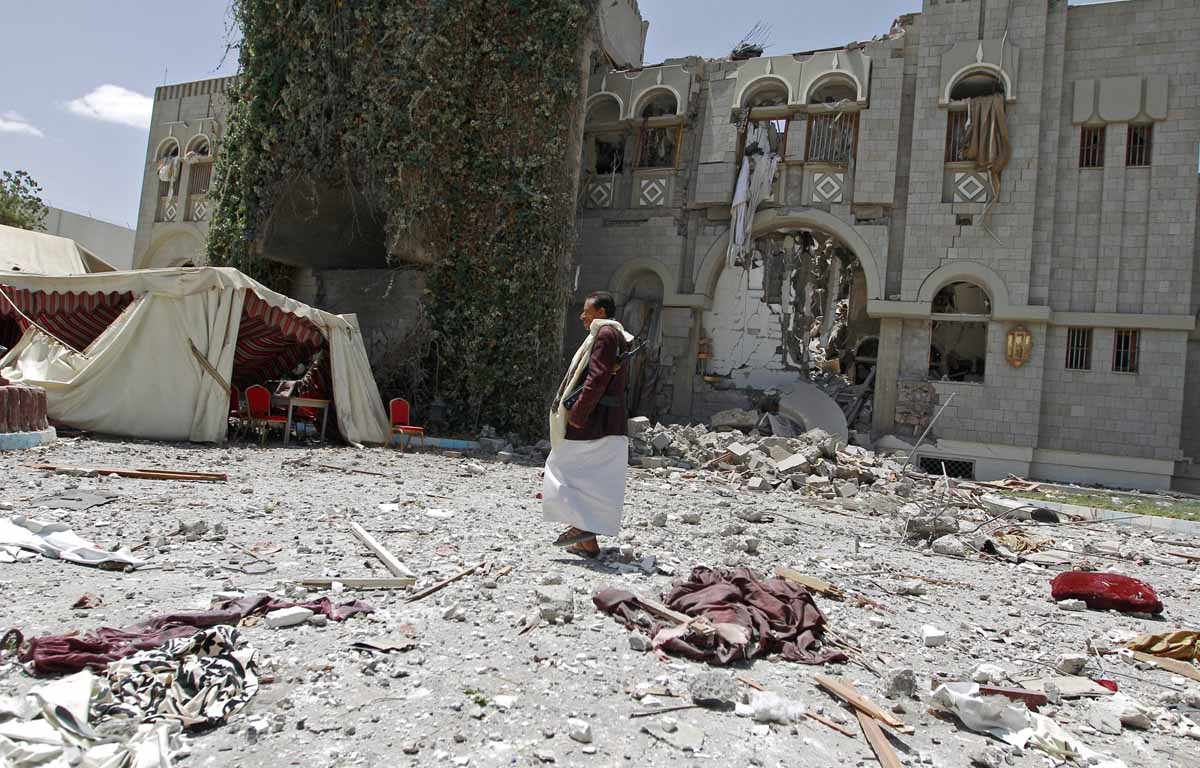 A gunmen loyal to former Yemeni President Ali Abdullah Saleh, stands amid the wreckage of Saleh's residence following reported air strikes on his residence, on May 10, 2015, in the capital Sanaa. 