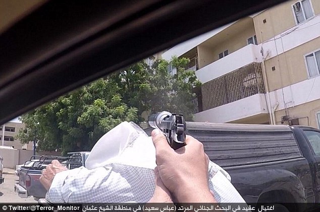 Pictures show a fanatic pointing a gun with a silencer attachment out of the window of a car before shooting a man in the back of the head in the war-torn city of Aden, Yemen