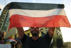 a-young-yemeni-man-holds-the-flag