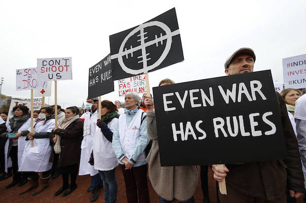 The staff of Medecins Sans Frontieres (MSF), also known as Doctors Without Borders, demonstrates in Geneva, Switzerland November 3, 2015, one month after the U.S. bombing of their charity-run hospital in Kunduz in Afghanistan. The United States, which has apologised for the attack, is conducting an investigation, but MSF wants an independent humanitarian commission created under the Geneva Conventions in 1991 to be activated for the first time to handle the inquiry. REUTERS/Denis Balibouse - RTX1UK05