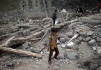 A boy walks on rubble of a house after it was destroyed by a Saudi-led air strike in Yemen's capital Sanaa, August 11, 2016. REUTERS/Mohamed al-Sayaghi