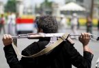 An armed man loyal to the Houthi movement holds his weapon as he gathers to protest against the Saudi-backed exiled government deciding to cut off the Yemeni central bank from the outside world, in the capital Sanaa, Yemen August 25, 2016. REUTERS/Mohamed al-Sayaghi